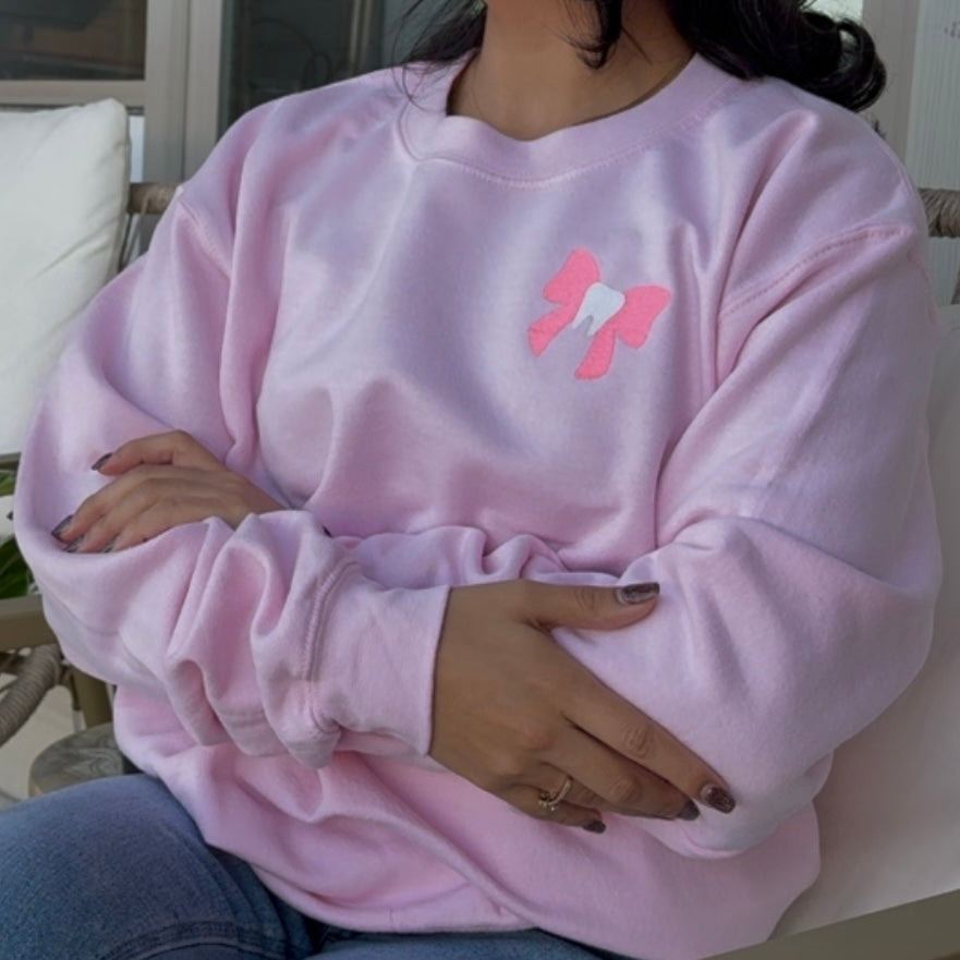 Pink tooth bow sweater